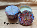Peppermint scented mosaic candle encassed in a stunning vibrant tin. It blends striking visual artistry with a premium fragrance experience! 